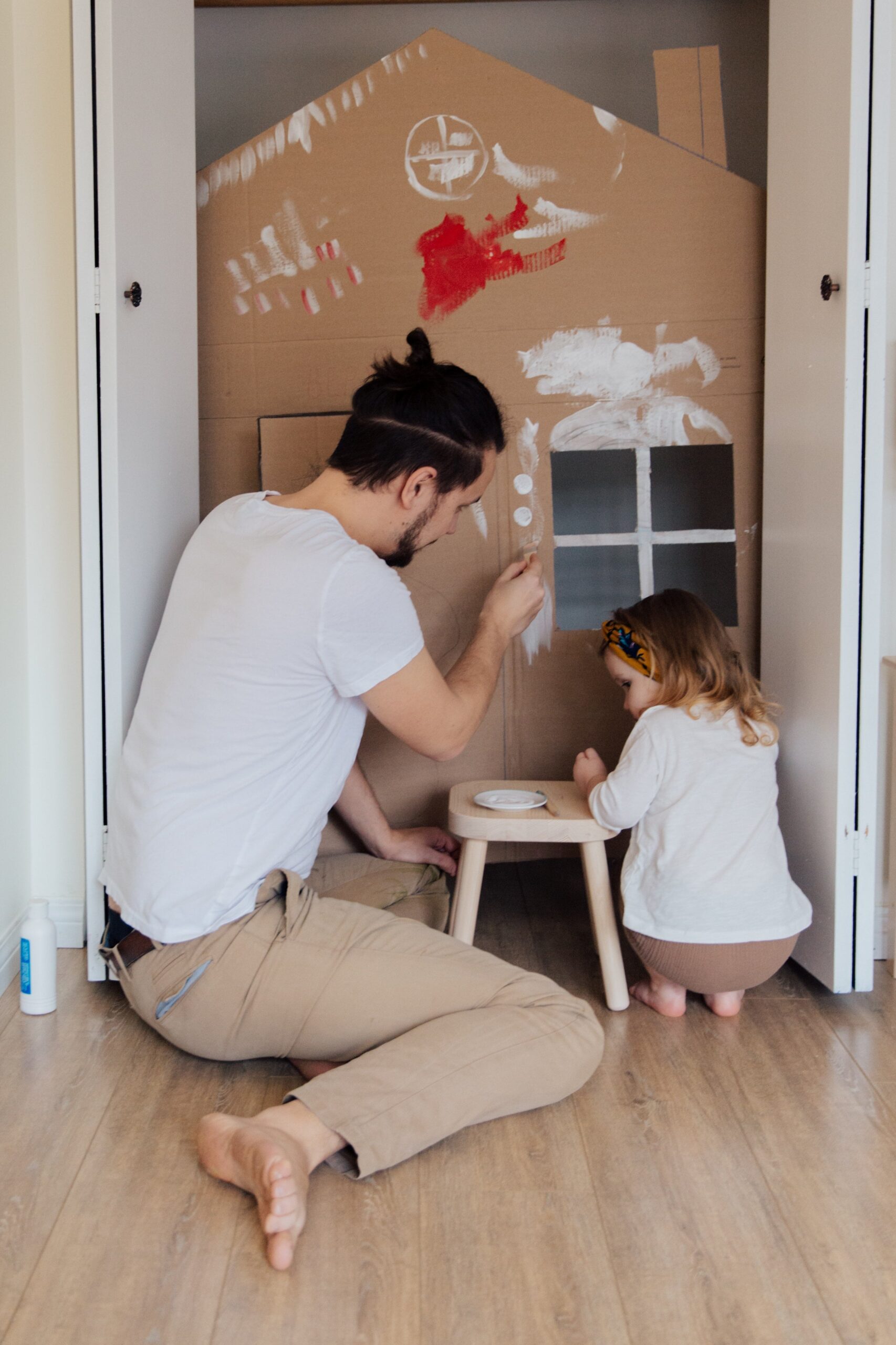 father and daughter playing together after buying home