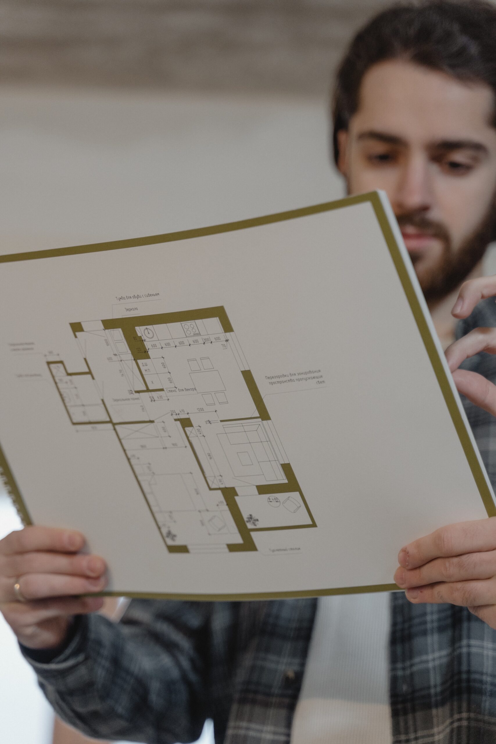 Man looking at blueprint for new home construction 